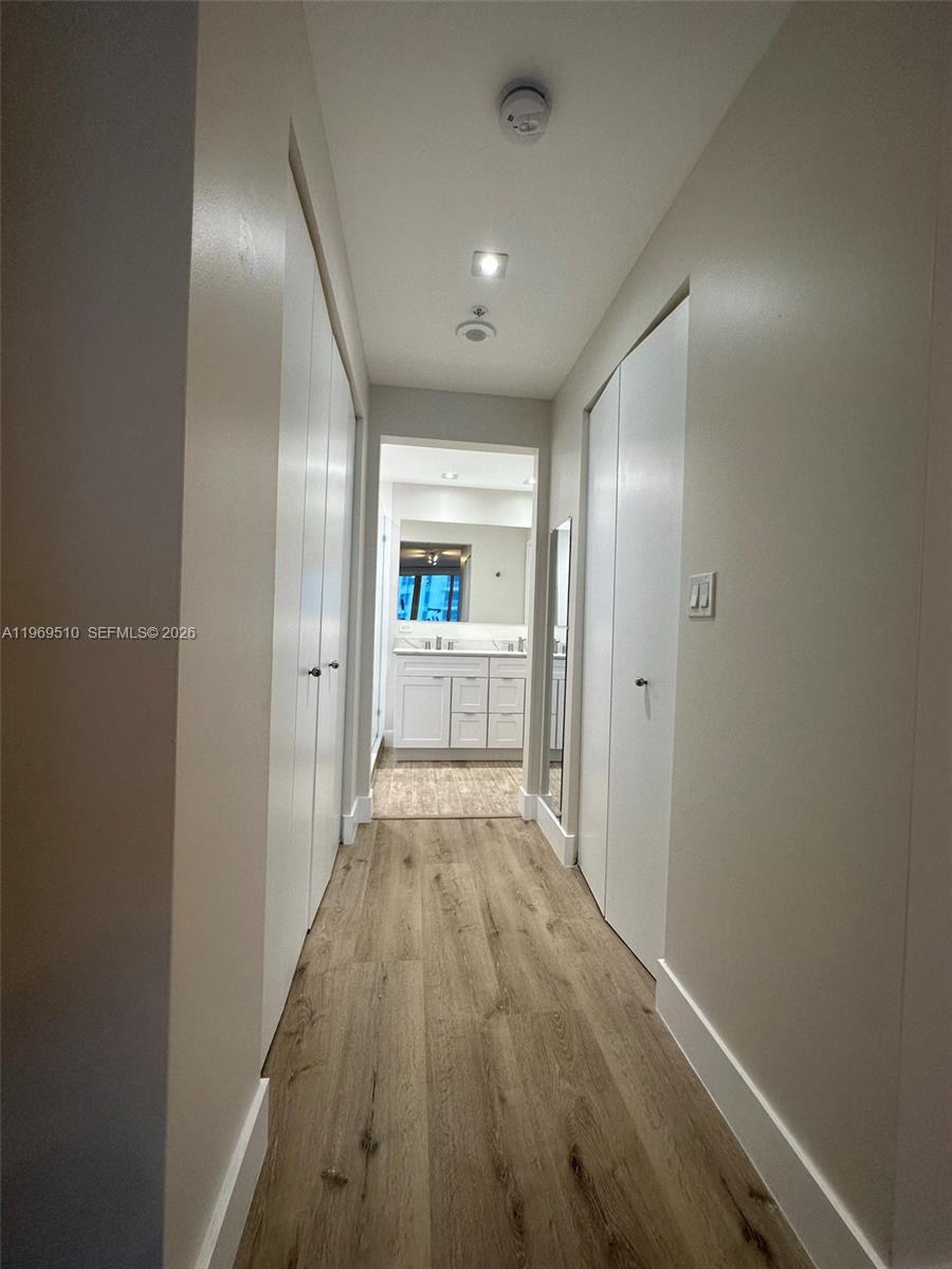 801 Brickell Key Boulevard, Unit 809 Miami, FL 33131 - Photo 6 of 17 a view of a hallway with wooden floor