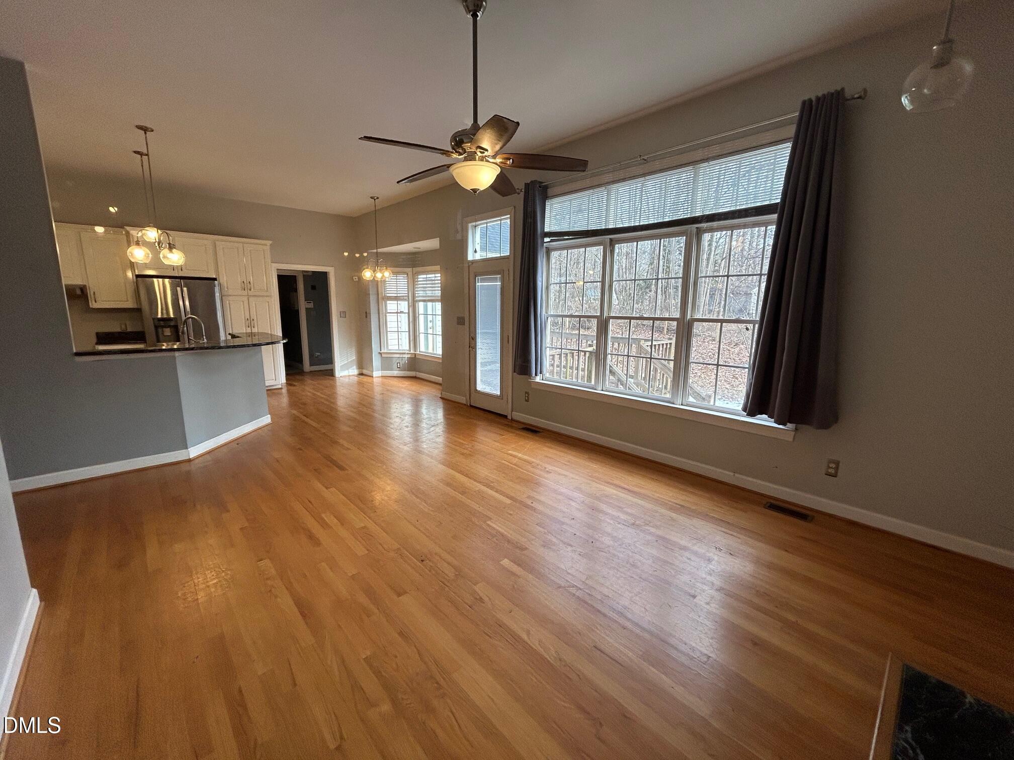 1220 Oxford Loop Road Oxford, NC 27565 - Photo 11 of 30 a view of an empty room with wooden floor and a window