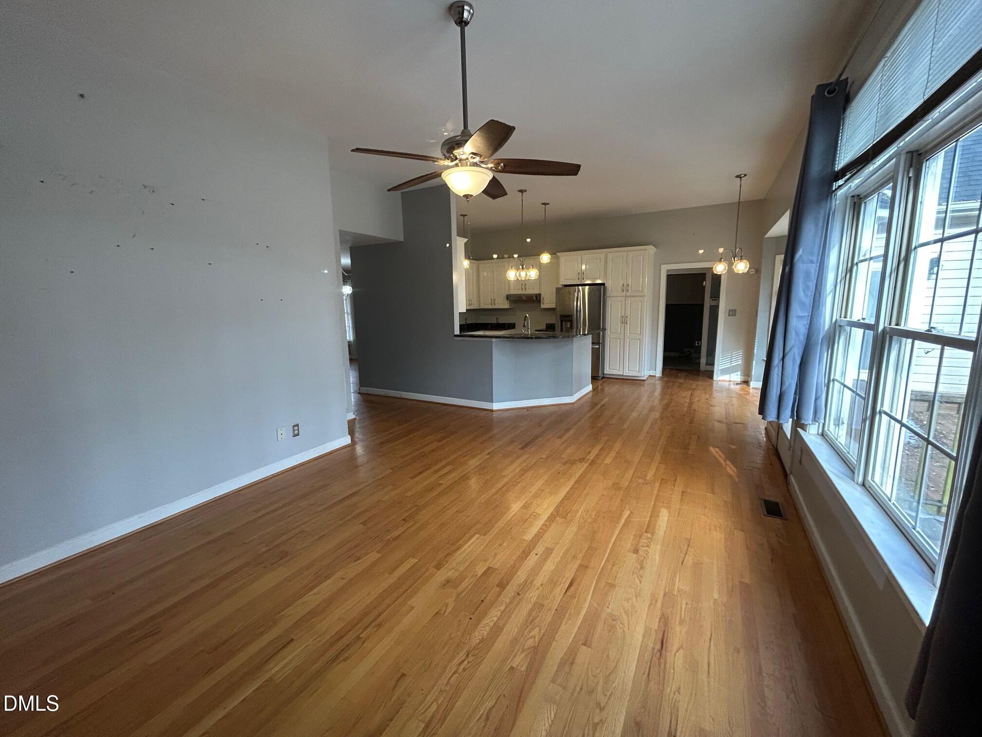 1220 Oxford Loop Road Oxford, NC 27565 - Photo 12 of 30 a view of a room with wooden floor ceiling fan and window