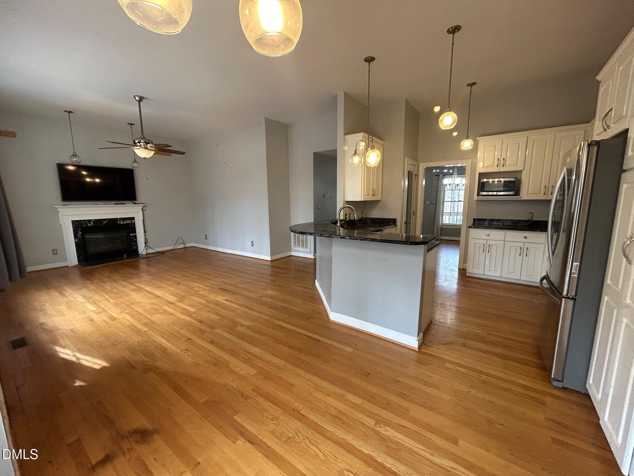1220 Oxford Loop Road Oxford, NC 27565 - Photo 13 of 30 a kitchen with granite countertop a stove a sink and a refrigerator