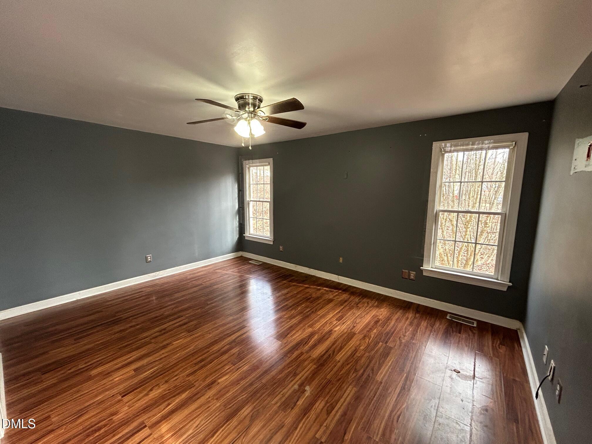 1220 Oxford Loop Road Oxford, NC 27565 - Photo 15 of 30 an empty room with wooden floor and windows