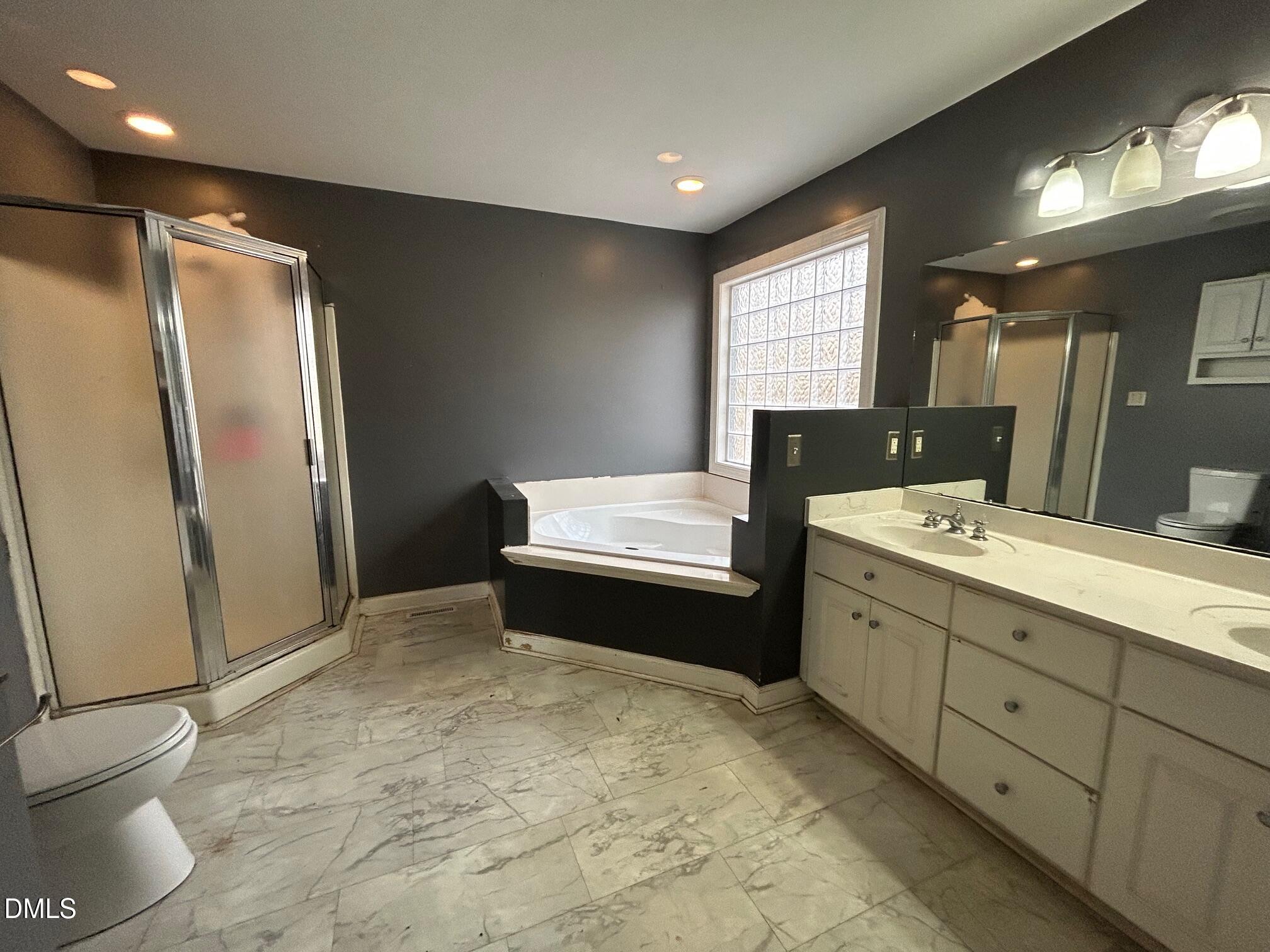 1220 Oxford Loop Road Oxford, NC 27565 - Photo 18 of 30 a bathroom with a double vanity sink toilet and shower