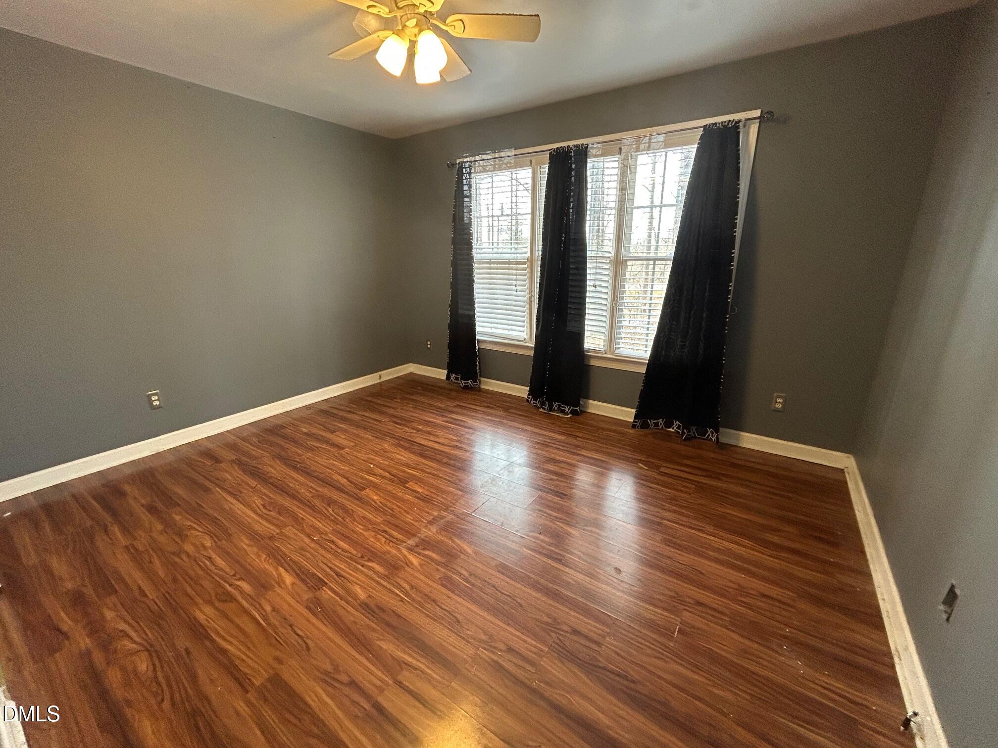 1220 Oxford Loop Road Oxford, NC 27565 - Photo 19 of 30 an empty room with wooden floor and windows