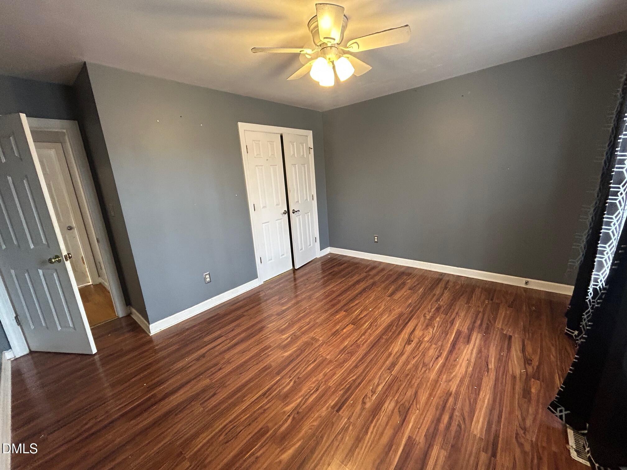 1220 Oxford Loop Road Oxford, NC 27565 - Photo 20 of 30 a view of empty room with wooden floor and fan