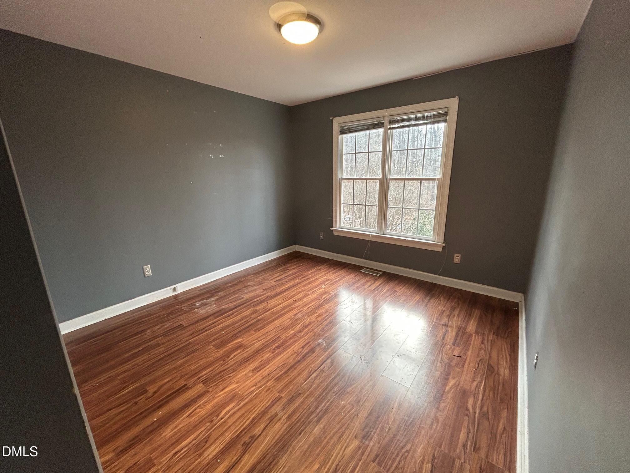1220 Oxford Loop Road Oxford, NC 27565 - Photo 22 of 30 wooden floor in an empty room with a window