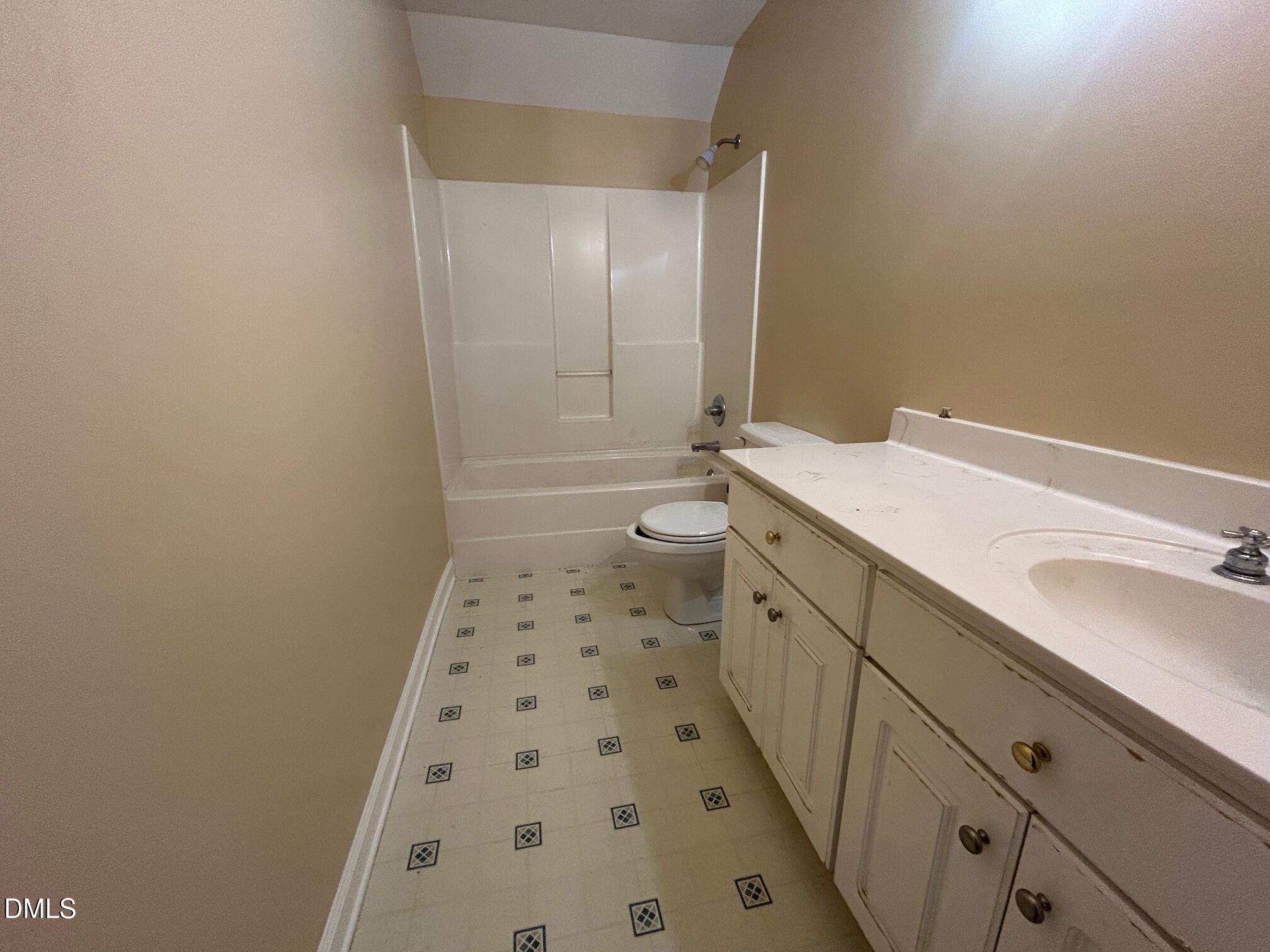 1220 Oxford Loop Road Oxford, NC 27565 - Photo 23 of 30 a bathroom with a sink a toilet a shower and a mirror