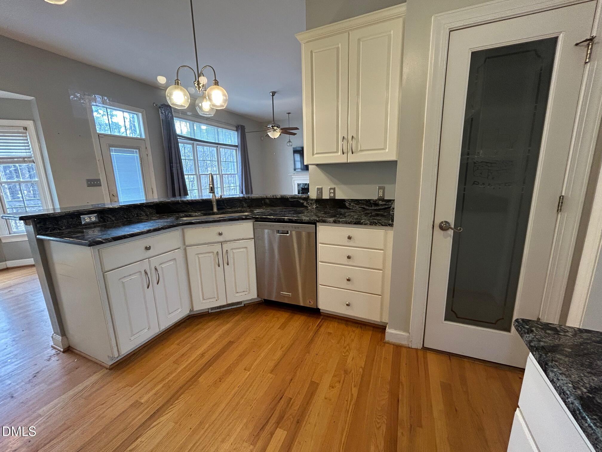 1220 Oxford Loop Road Oxford, NC 27565 - Photo 9 of 30 a kitchen with granite countertop a sink cabinets and wooden floor