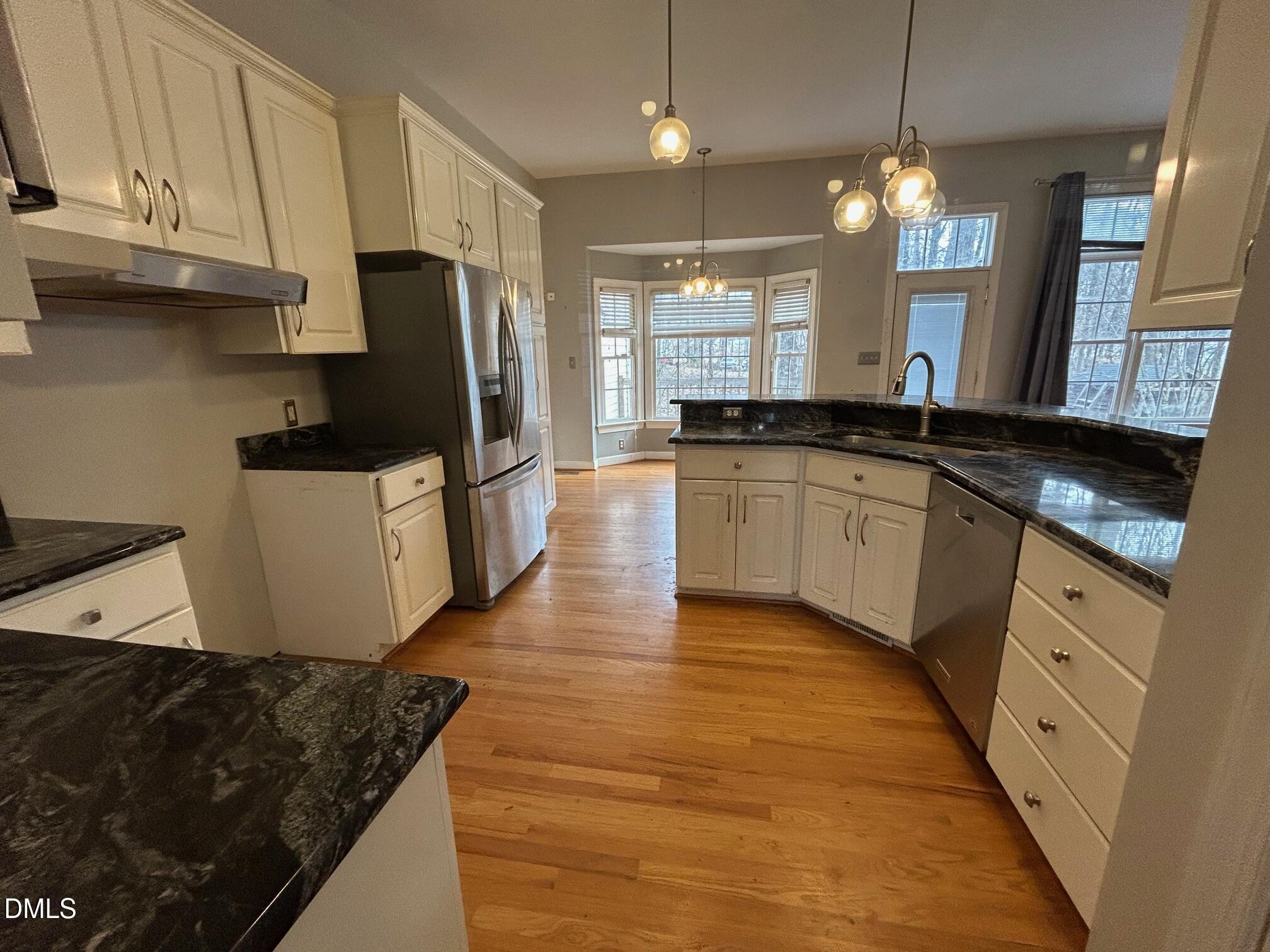 1220 Oxford Loop Road Oxford, NC 27565 - Photo 10 of 30 a kitchen with stainless steel appliances granite countertop a sink stove and refrigerator