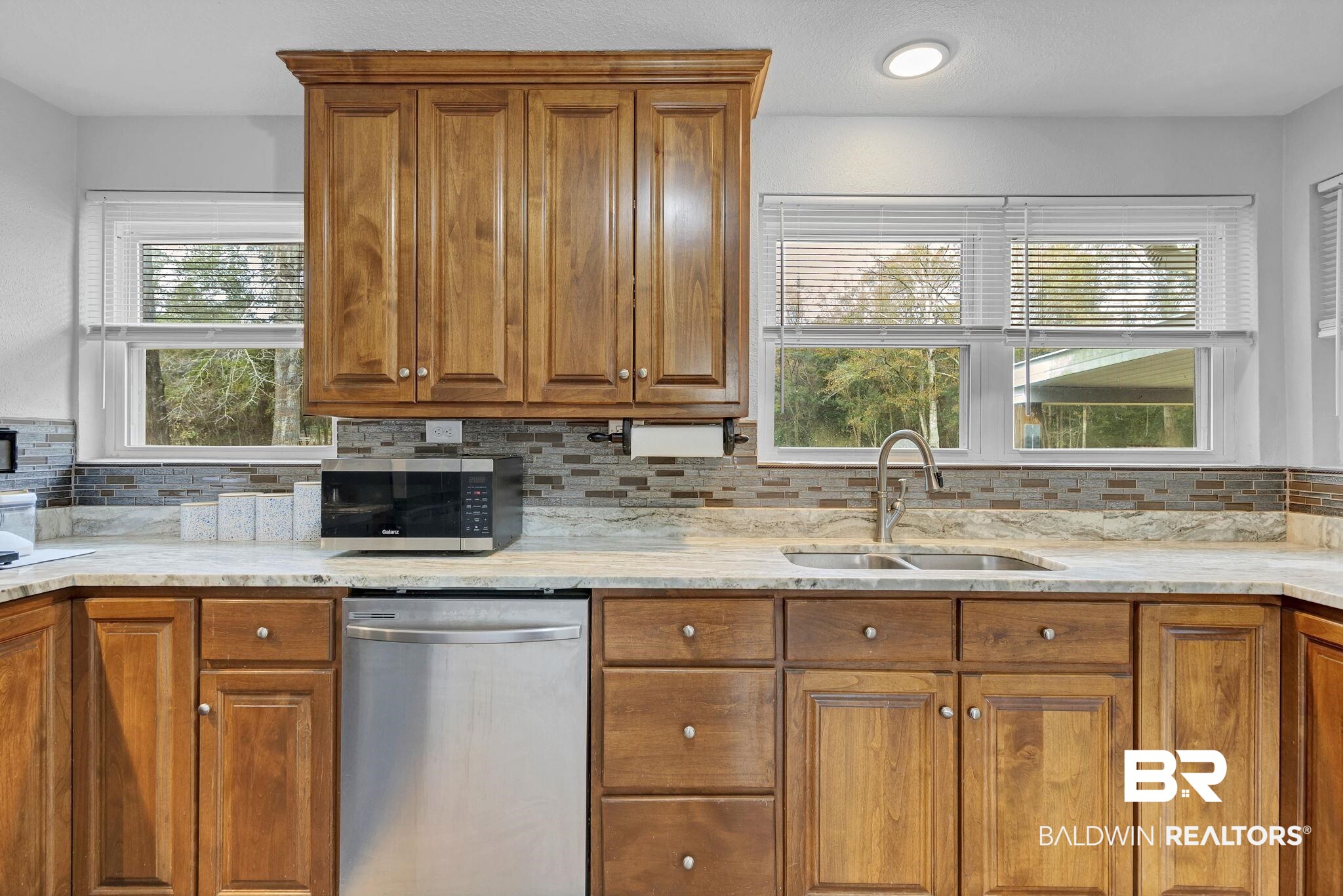 4690 Lott Road Eight Mile, AL 36613 - Photo 18 of 45 Kitchen with stainless steel appliances, plenty of natural light, sink, and decorative backsplash