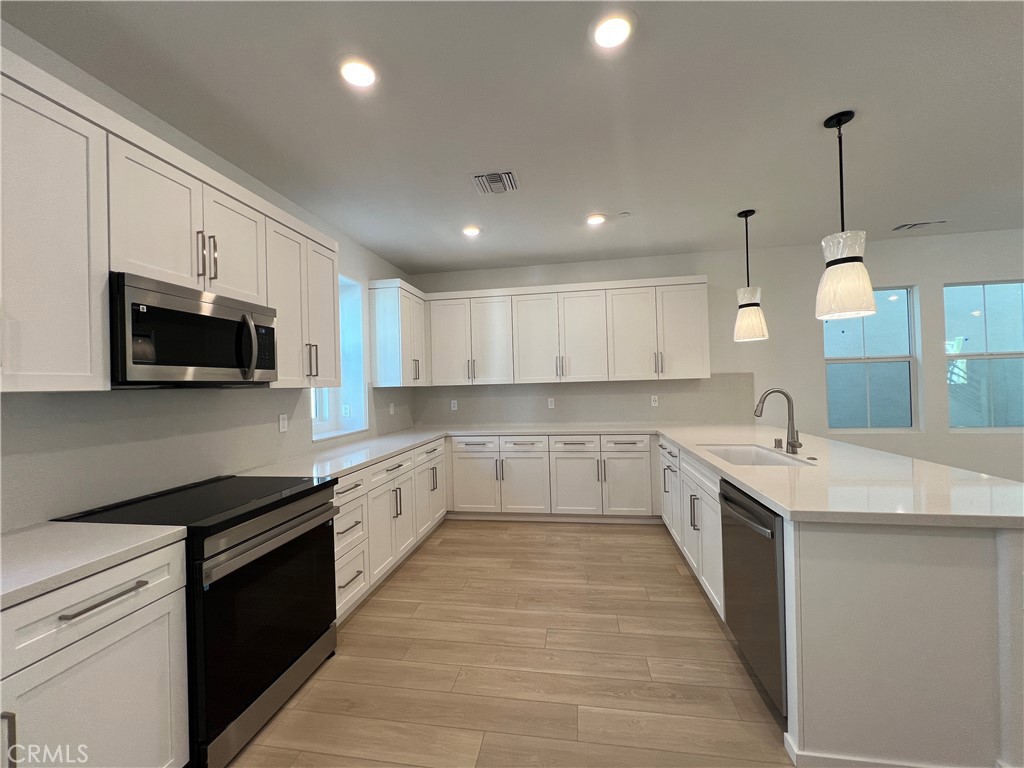 2543 Dorris Street El Monte, CA 91733 - Photo 2 of 13 a large kitchen with stainless steel appliances lots of counter space sink and cabinets