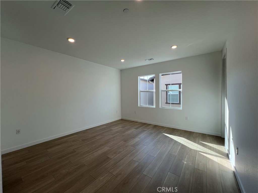 2543 Dorris Street El Monte, CA 91733 - Photo 10 of 13 an empty room with wooden floor and windows