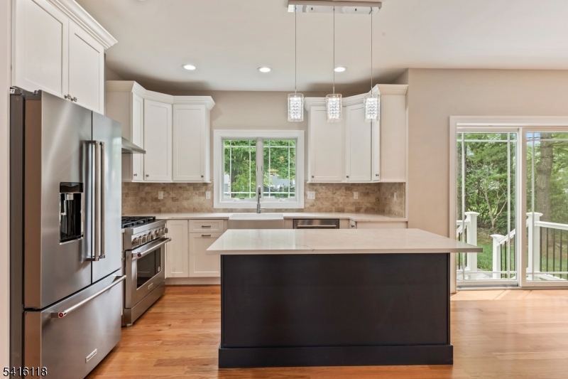 118 Cambridge Road Westfield, NJ 07090 - Photo 13 of 50 a kitchen with stainless steel appliances granite countertop a stove a refrigerator a sink and a oven with wooden floor