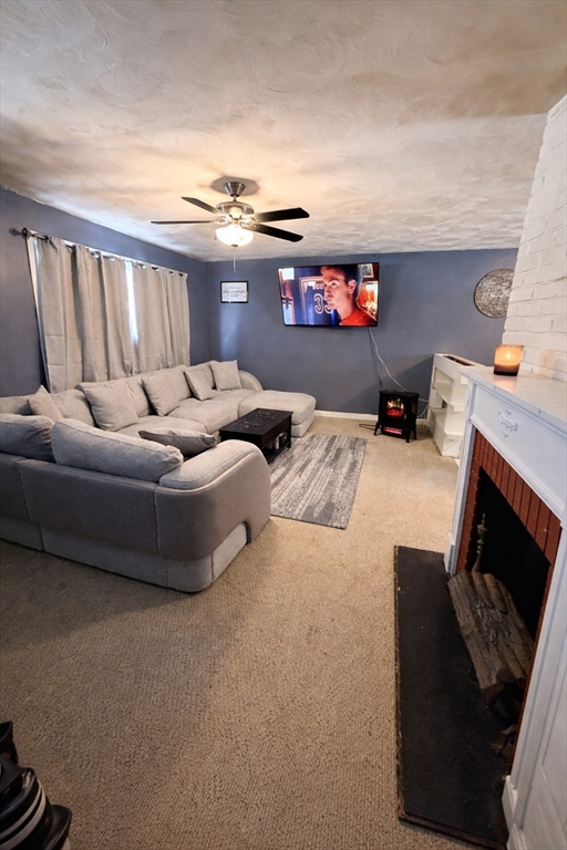 133 Ardsley Circle Brockton, MA 02302 - Photo 5 of 16 a living room with furniture and a fireplace