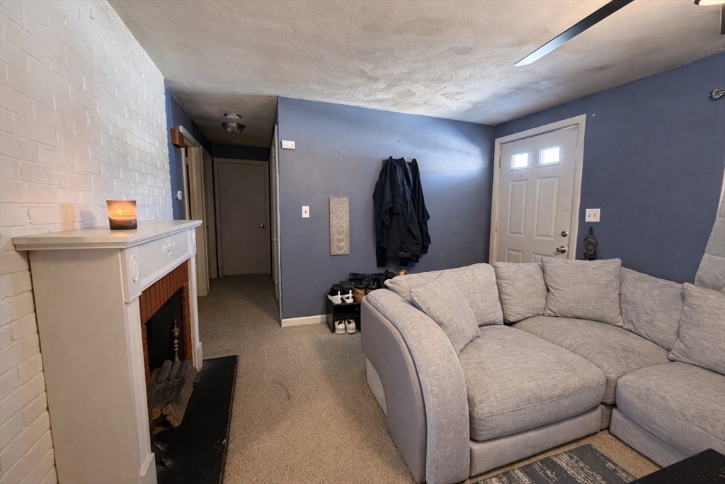 133 Ardsley Circle Brockton, MA 02302 - Photo 6 of 16 a living room with furniture and a fireplace