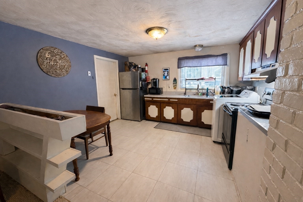 133 Ardsley Circle Brockton, MA 02302 - Photo 7 of 16 a kitchen with stainless steel appliances granite countertop a refrigerator sink and cabinets