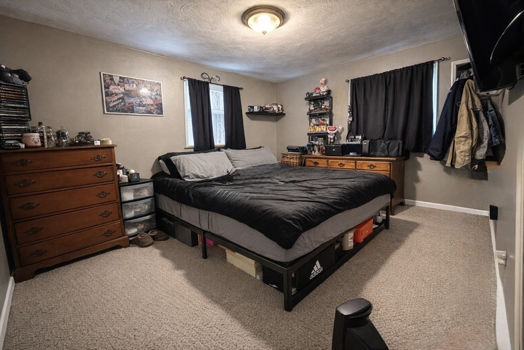 133 Ardsley Circle Brockton, MA 02302 - Photo 8 of 16 a bed sitting in a bedroom and night stand