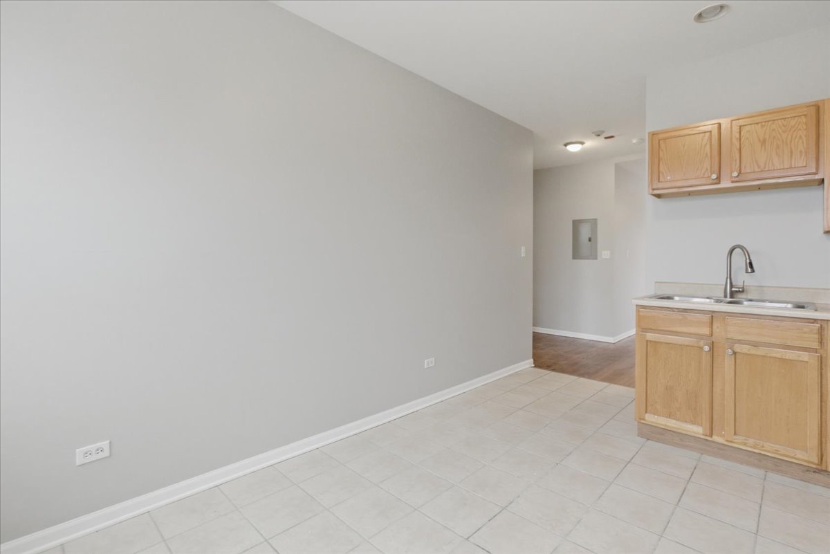 7039 West Roosevelt Road, Unit 2F Oak Park, IL 60402 - Photo 4 of 12 a view of a kitchen with white cabinets