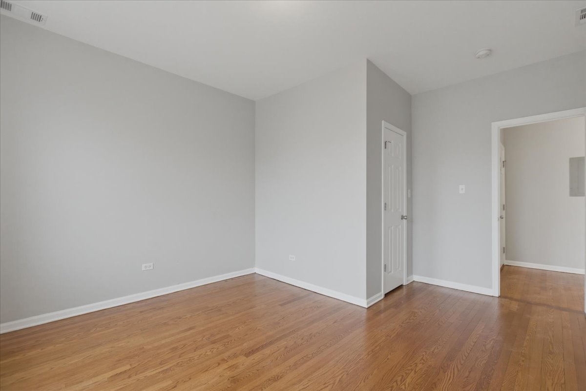 7039 West Roosevelt Road, Unit 2F Oak Park, IL 60402 - Photo 9 of 12 a view of an empty room with wooden floor