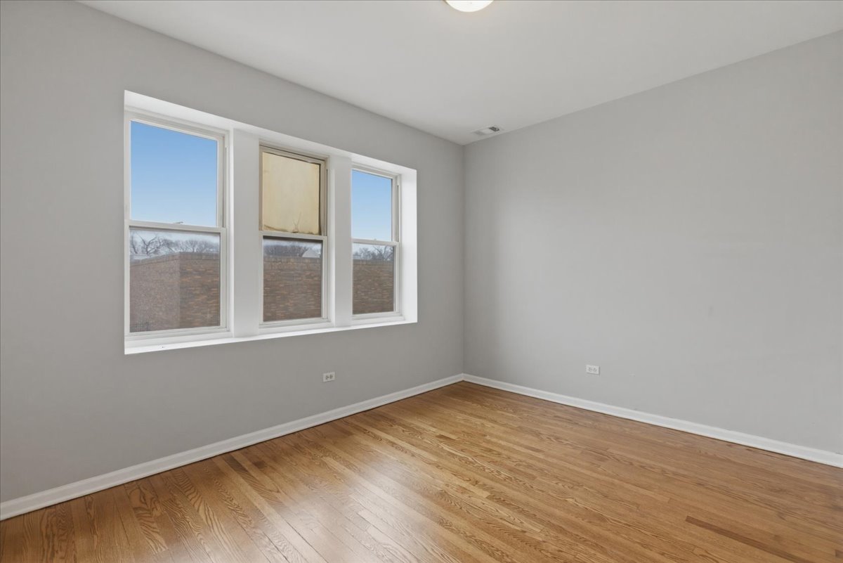 7039 West Roosevelt Road, Unit 2F Oak Park, IL 60402 - Photo 10 of 12 a view of empty room with wooden floor and fan