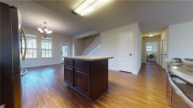a kitchen with stainless steel appliances granite countertop a sink stove and microwave