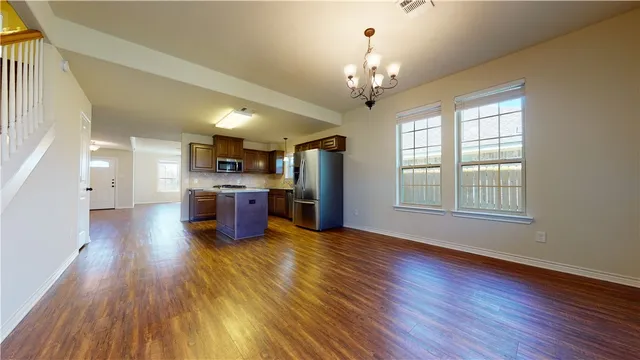 an aerial view of a house with floor to ceiling window and a kitchen