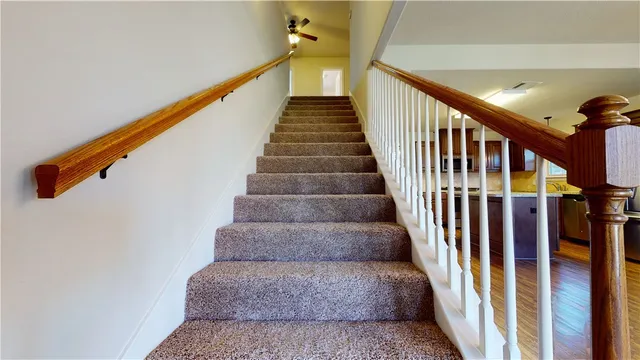 a large kitchen with stainless steel appliances granite countertop a stove oven a refrigerator with cabinets and wooden floor