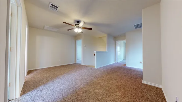 a view of a livingroom with a ceiling fan and window