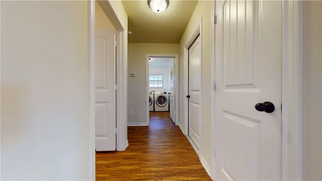 a view of a room with a ceiling fan and window