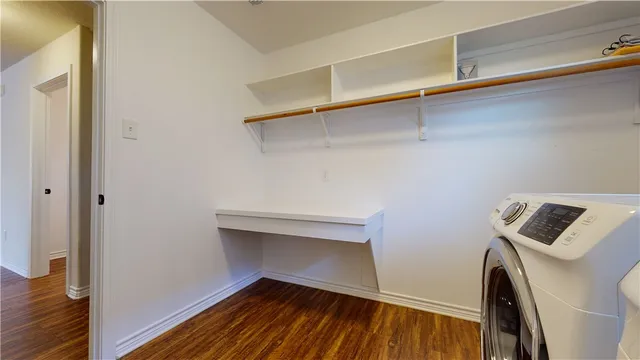 a bathroom with a toilet sink vanity and mirror