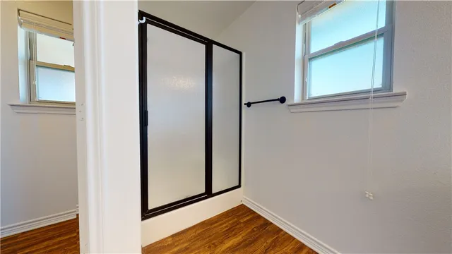 a bathroom with a sink vanity granite tub and a mirror