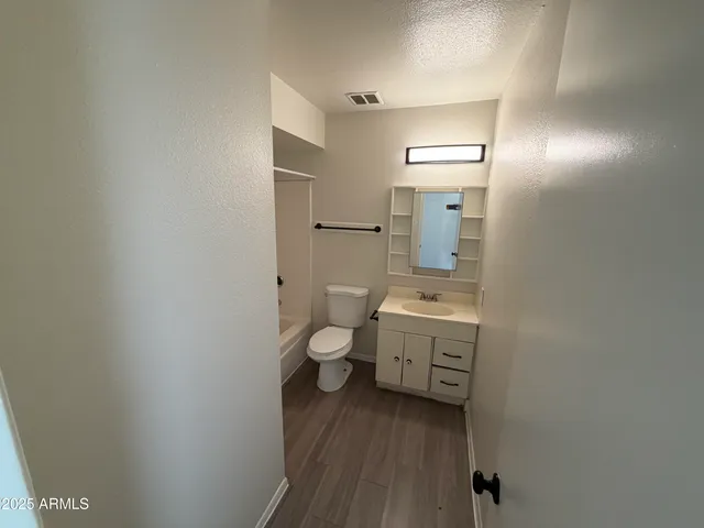 a bathroom with a toilet a sink and mirror