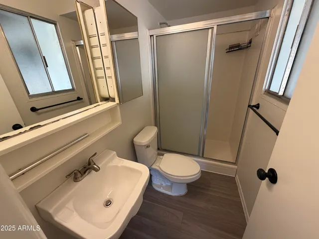 a bathroom with a sink toilet and shower