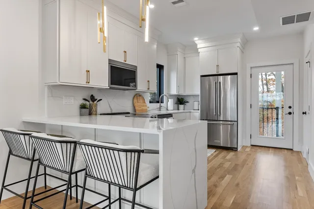 a kitchen with stainless steel appliances a refrigerator stove microwave and cabinets