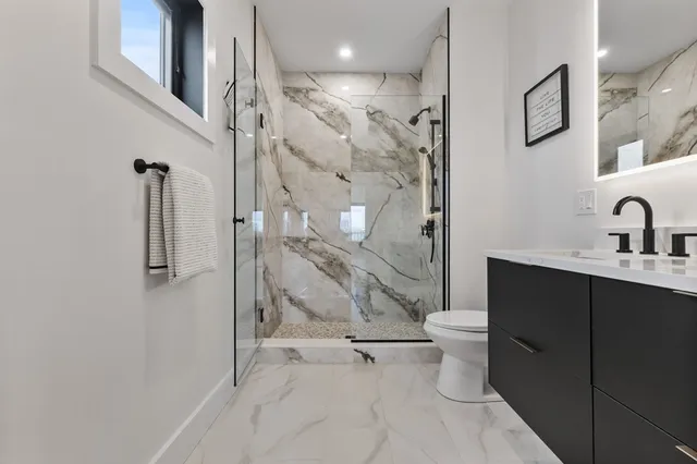 a bathroom with a sink toilet and shower