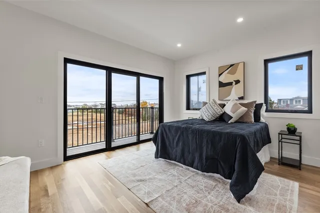 a bedroom with a large bed and a large window