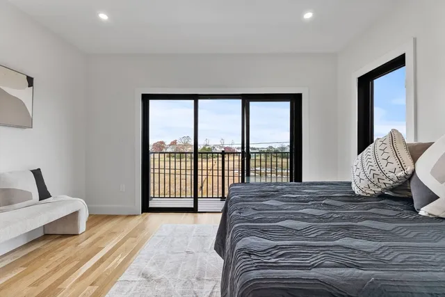 a spacious bedroom with a large bed and a large window