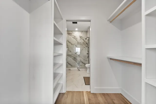 a view of a room with wooden floor