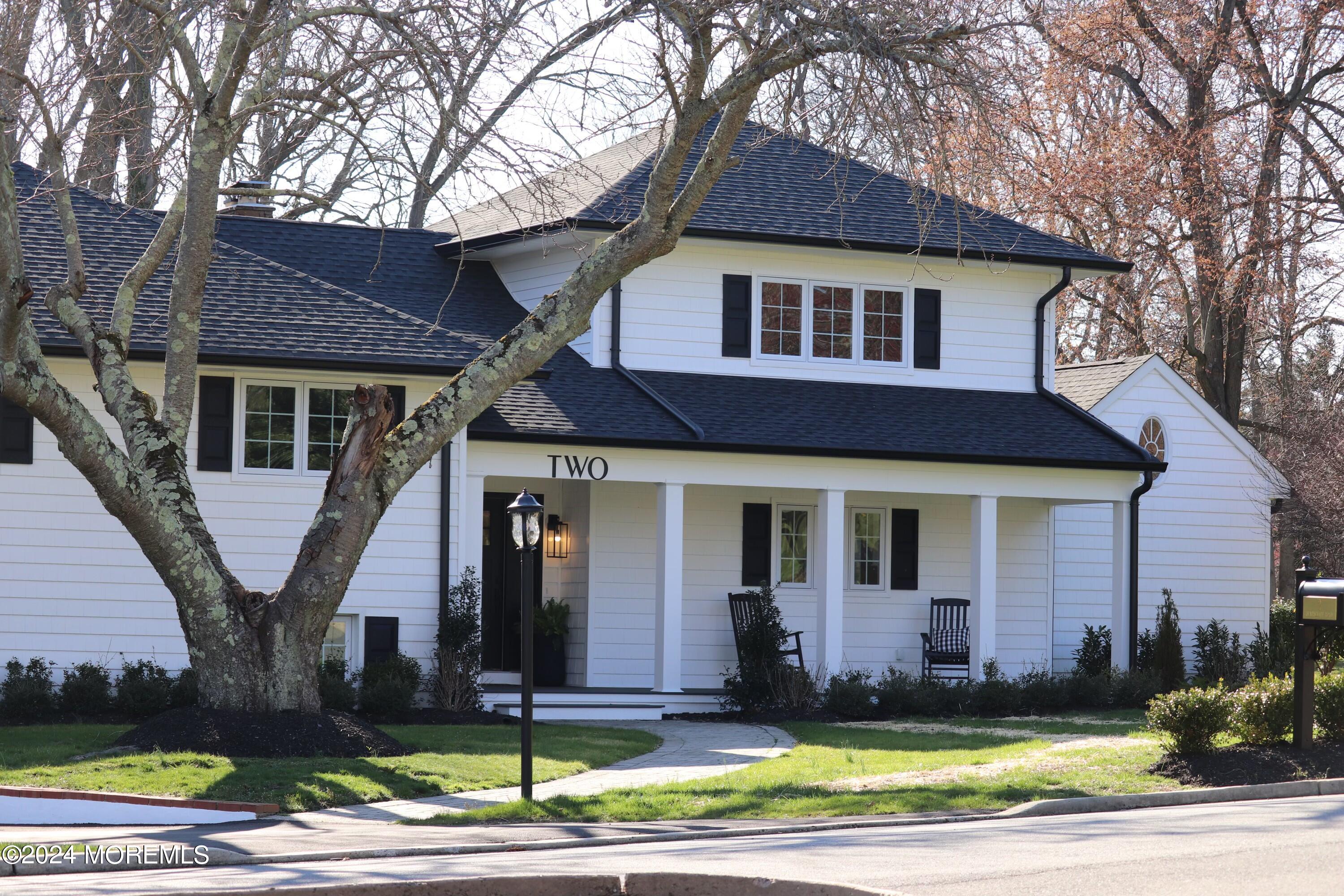 2 Heathcliff Road Rumson, NJ 07760 - Photo 2 of 38 a view of a white house with large windows and a table and chairs