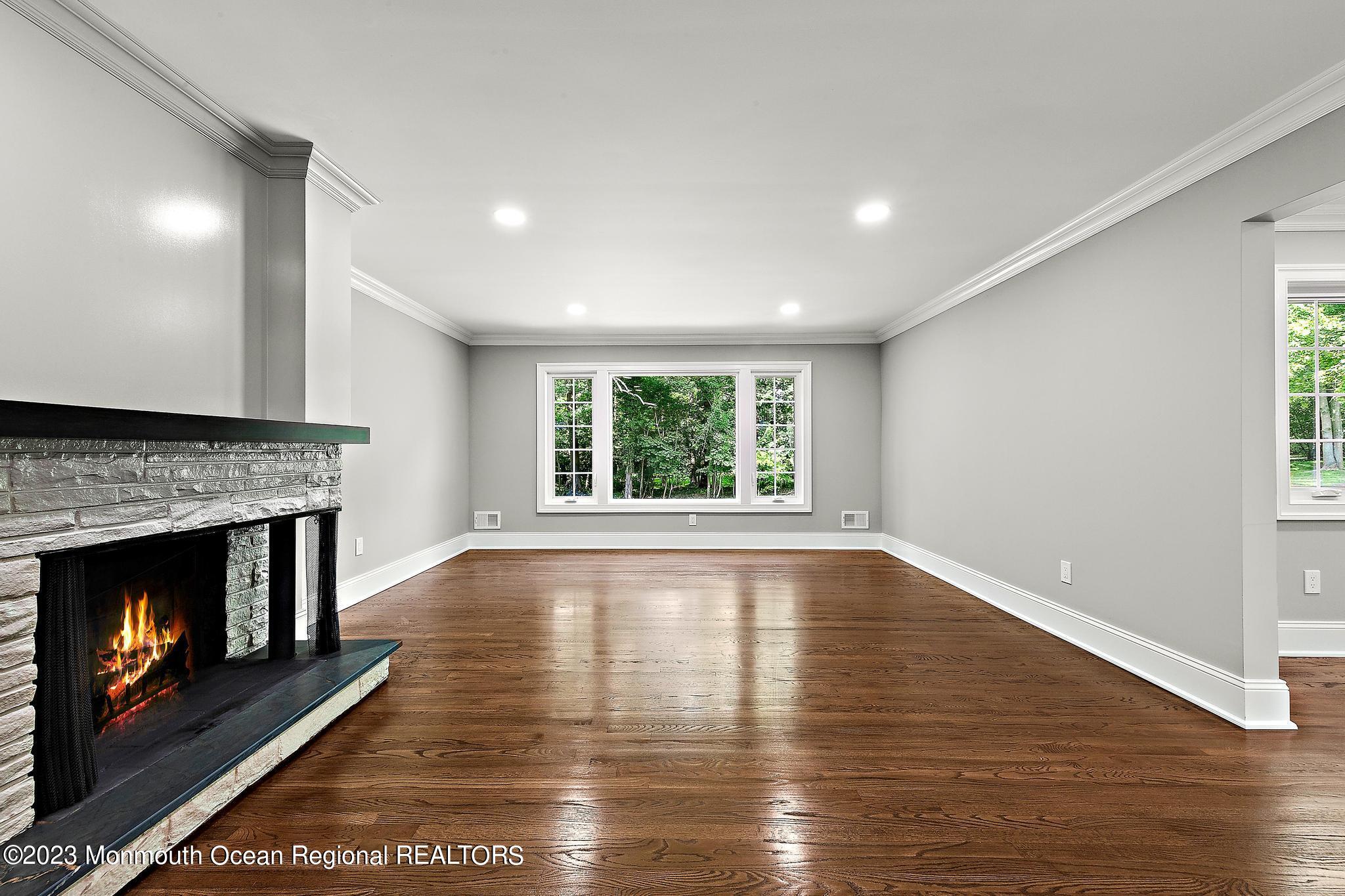 2 Heathcliff Road Rumson, NJ 07760 - Photo 10 of 38 a view of an empty room with wooden floor fireplace and a window