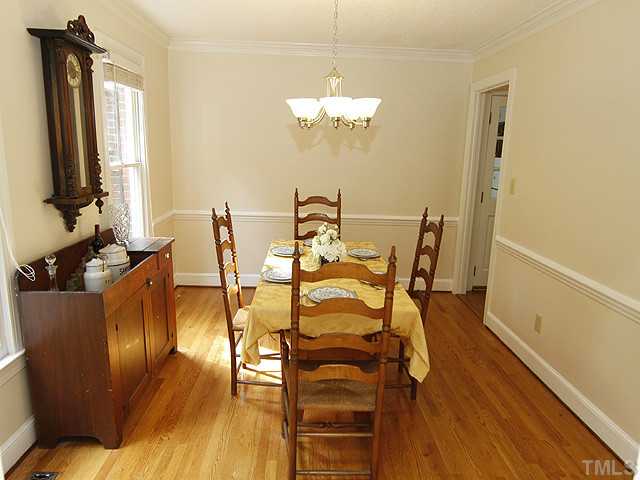7908 Farnham Court Raleigh, NC 27615 - Photo 6 of 25 Natural Light - Warm Hardwood Floors - Chairrail & Crown Molding Creates the Perfect Dining Room for Family & Social Gatherings