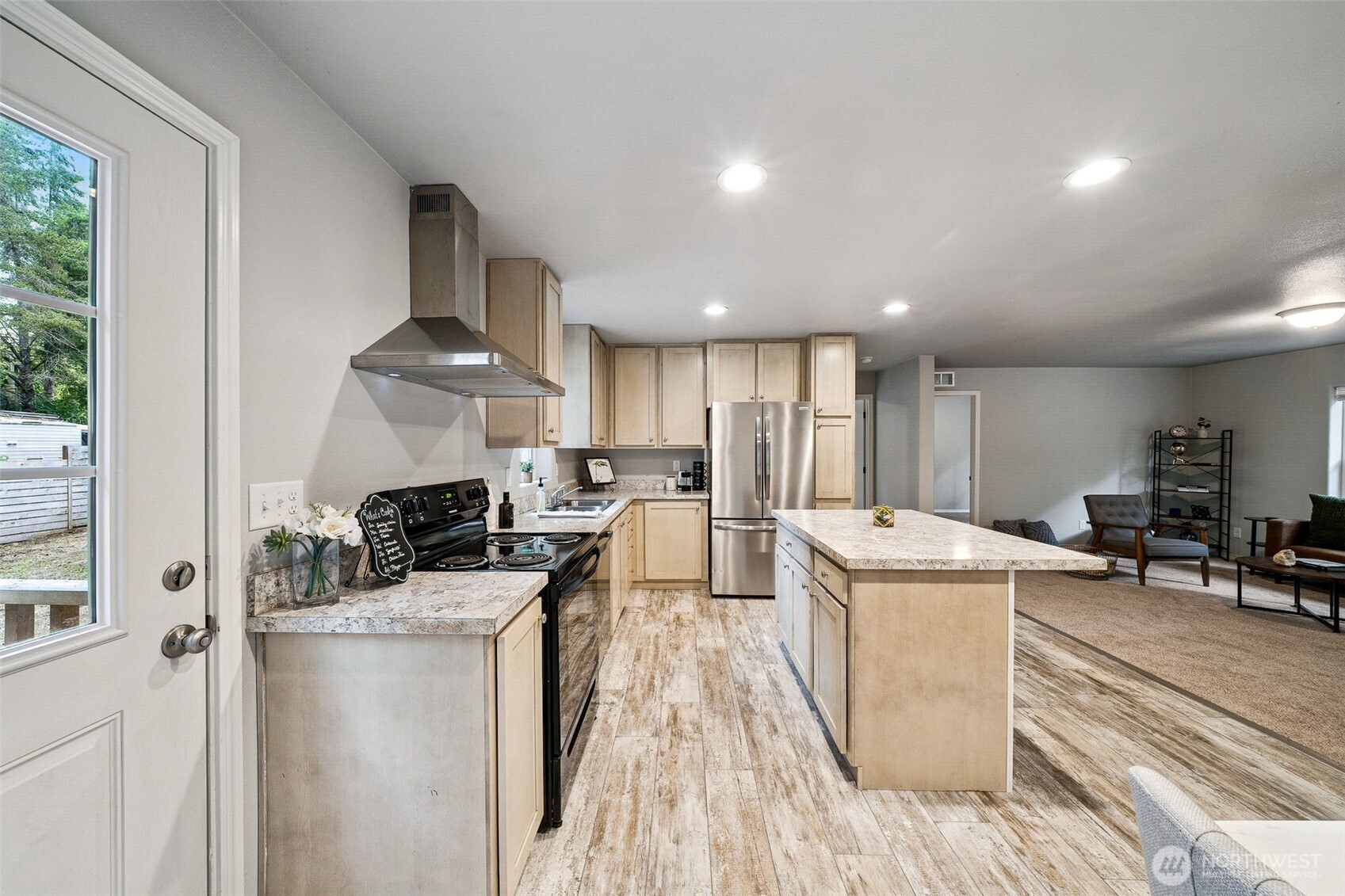 8107 Mazama Court Southwest Olympia, WA 98512 - Photo 11 of 34 a kitchen with stainless steel appliances a stove a sink a refrigerator and cabinets