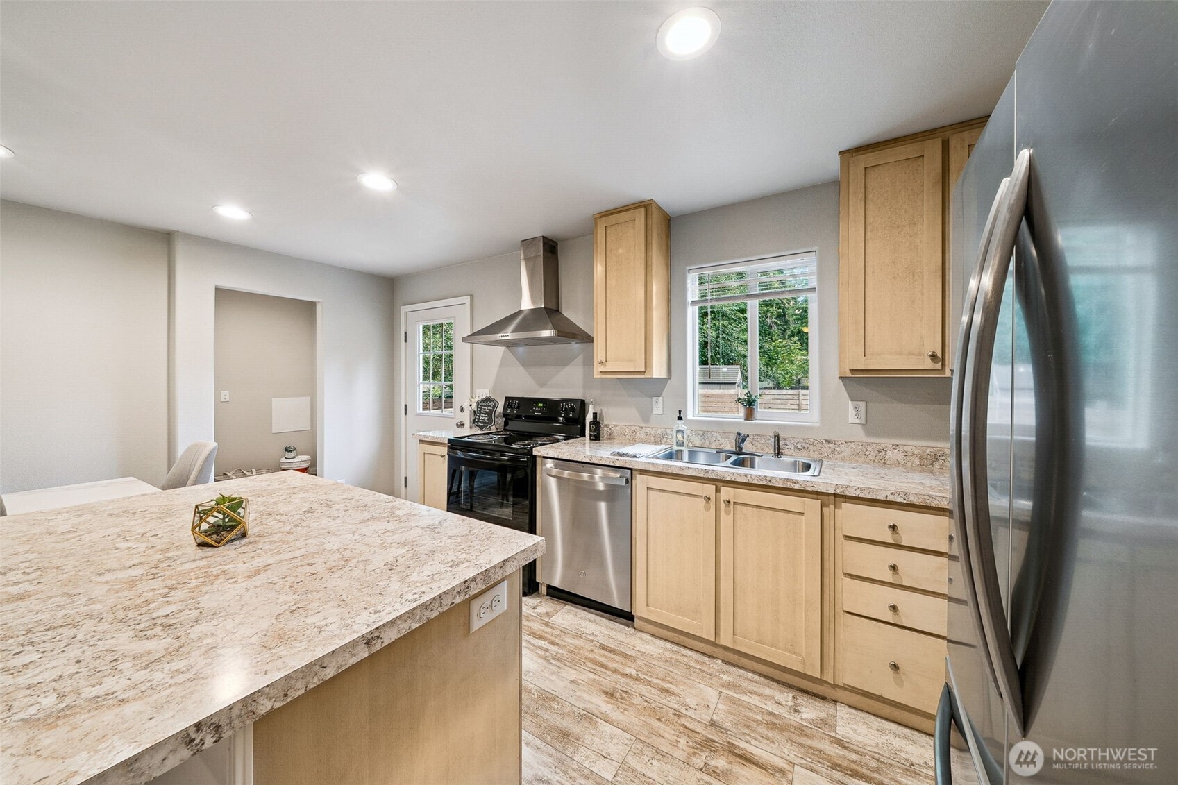 8107 Mazama Court Southwest Olympia, WA 98512 - Photo 12 of 34 a kitchen with stainless steel appliances granite countertop a sink stove and refrigerator