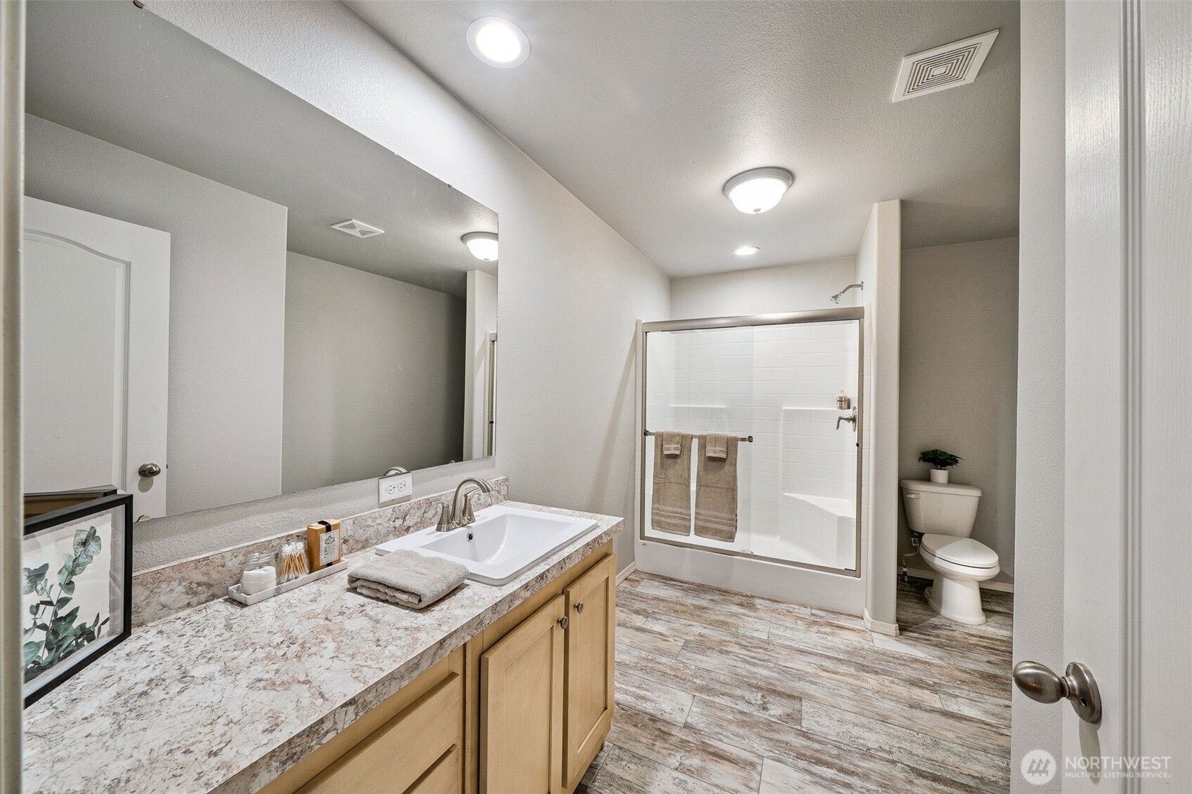 8107 Mazama Court Southwest Olympia, WA 98512 - Photo 15 of 34 a bathroom with a granite countertop sink and a mirror