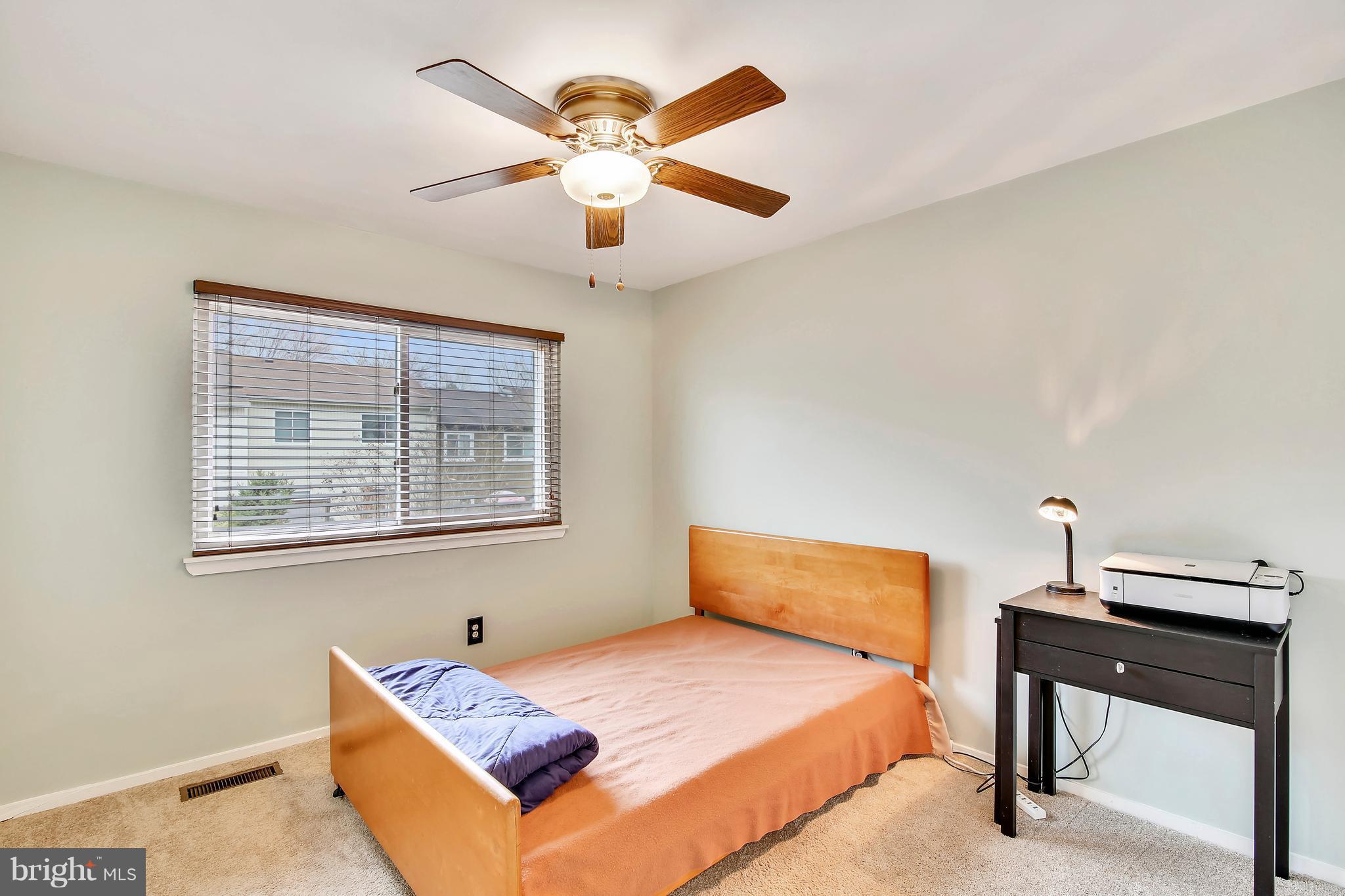19406 Thomas Farm Road Gaithersburg, MD 20886 - Photo 11 of 15 a bedroom with a bed and a chandelier