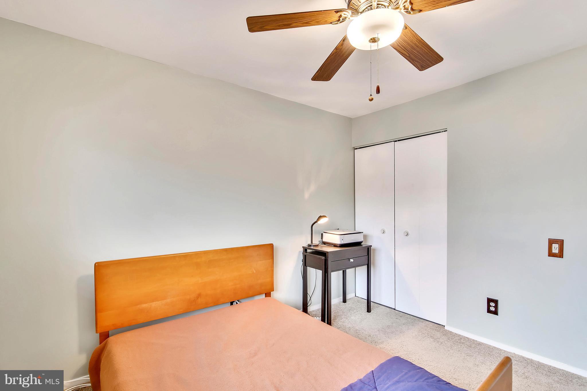 19406 Thomas Farm Road Gaithersburg, MD 20886 - Photo 12 of 15 a bedroom with a bed and a chandelier
