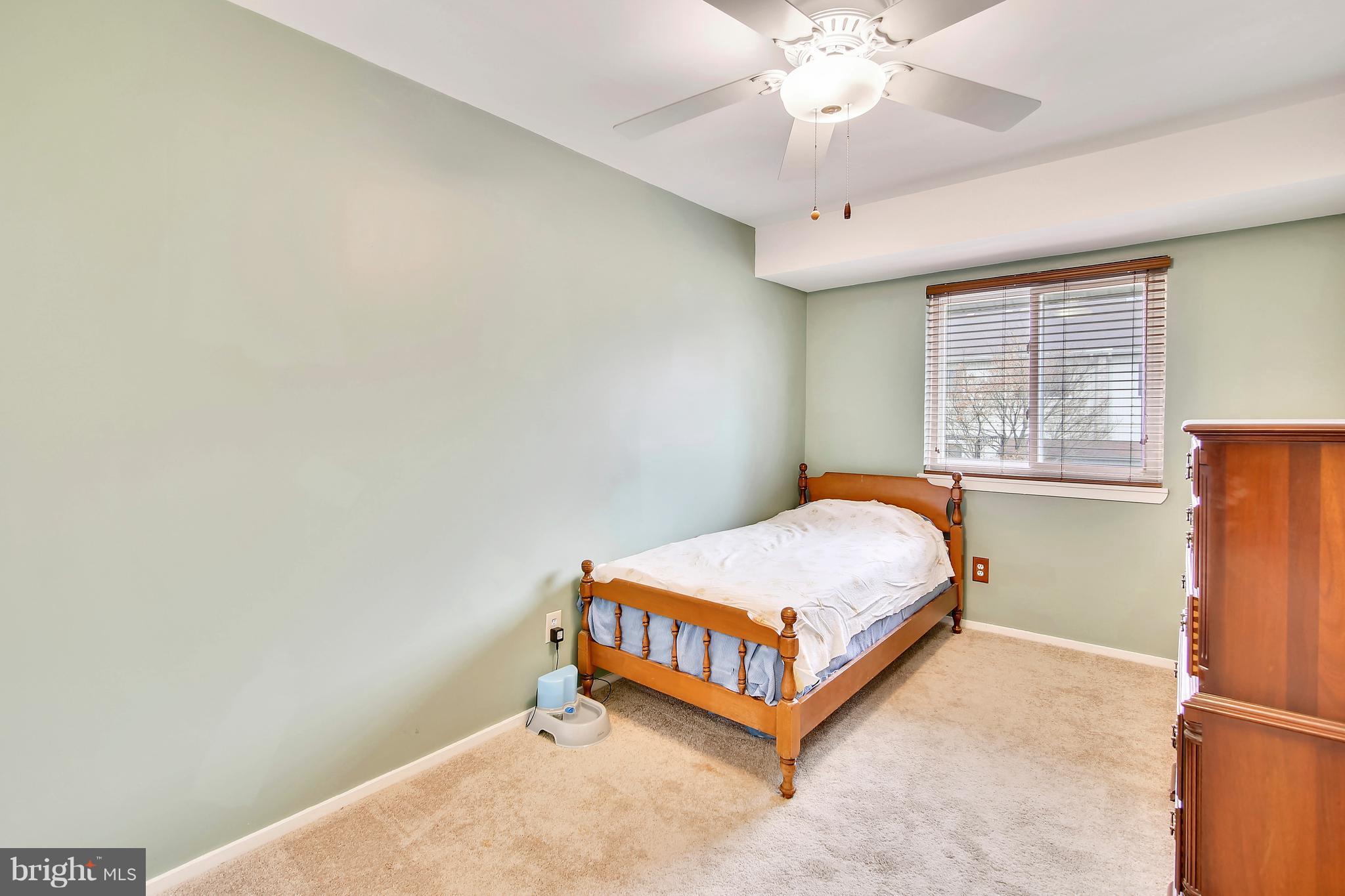 19406 Thomas Farm Road Gaithersburg, MD 20886 - Photo 13 of 15 a bed room with a bed and a chandelier