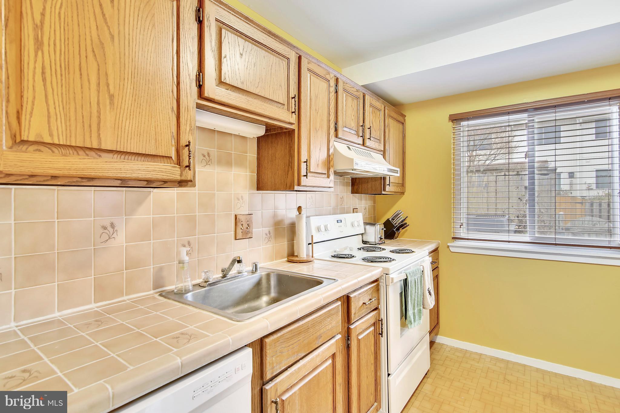 19406 Thomas Farm Road Gaithersburg, MD 20886 - Photo 7 of 15 a kitchen with stainless steel appliances granite countertop a sink and cabinets