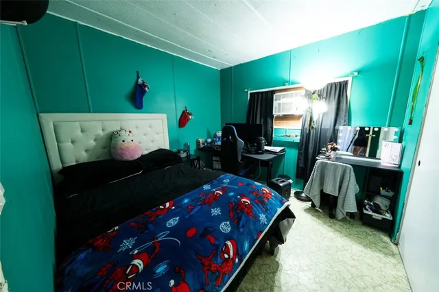 a bedroom with a bed and a flat tv screen
