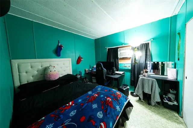 a bedroom with a bed and a flat tv screen