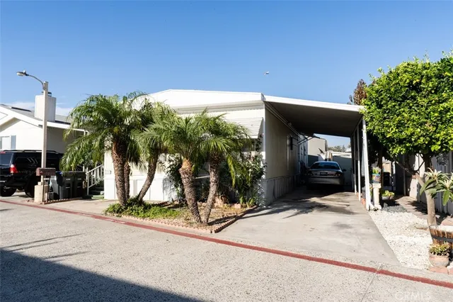 a view of a house with backyard and tree s